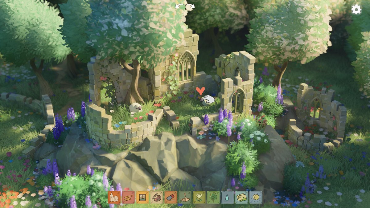  Une scène de construction, montrant une ruine médiévale entourée d’arbres et de fleurs. Cette capture dans Tiny Glade illustre la liberté de construction et l’ambiance de simulation relaxante du jeu sur Steam. - © Tiny Glade