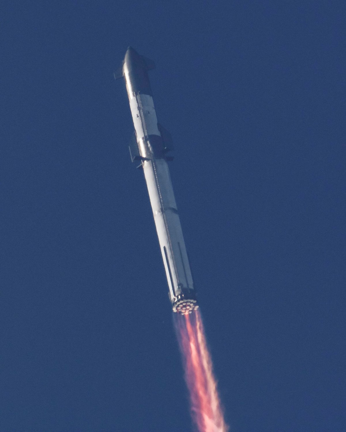 Starship et Super Heavy en vol. Notez les quelques moteurs déjà éteints parmi les 33 unités © SpaceX